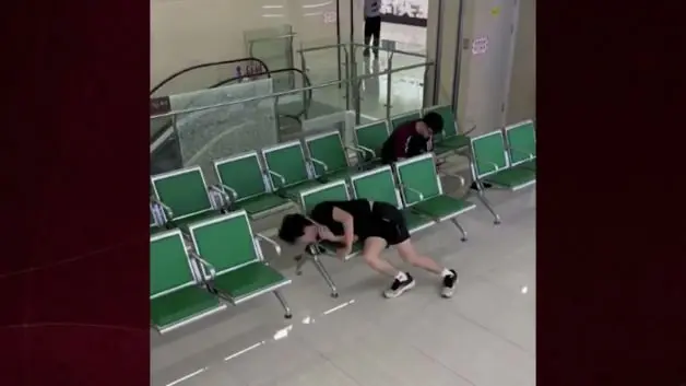 Çin'de bekleme salonunda kafası koltuğun kenarına sıkışan gencin zor anları